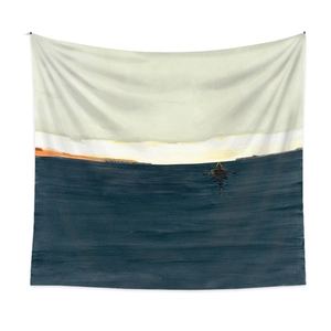 Detail of bohemian tapestry featuring a minimalist blue sea landscape and a small boat