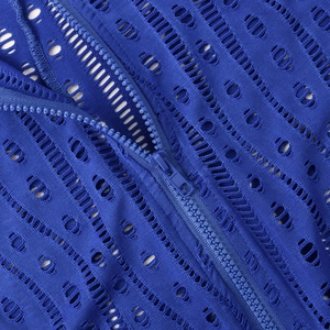 Detail shot of blue hollow-out mesh fabric with matching resin zipper closure