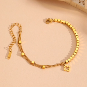 Gold double-layered stainless steel bracelet with clover pendant and metal beads