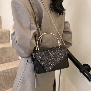 Chic black sequin flap crossbody bag with gold metal handle and chain shoulder strap