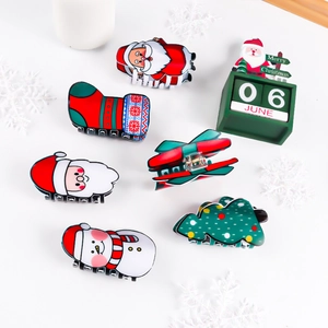 Christmas hair claws set featuring Santa, snowman and tree designs in red and green colors