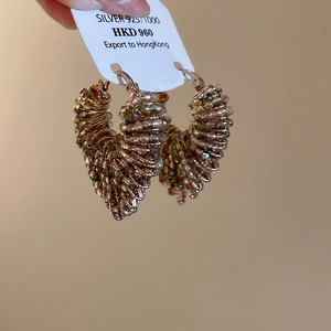 Macro detail of 925 silver hoop earrings with champagne crystal beads and rose gold finish
