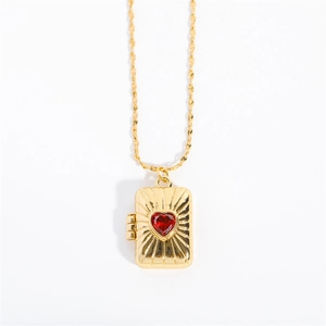 Golden rectangular locket pendant with a red heart gem and twisted rope chain detail