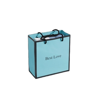 Elegant Tiffany blue paper gift bag with black handles and Best Love print for holidays