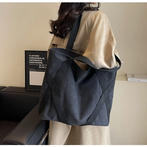 Close-up of charcoal black large canvas tote bag with reinforced shoulder straps for daily use