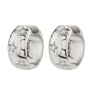 Close-up of polished silver hoop earrings with star engravings and micro-set zircons