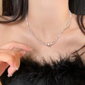 Elegant double-layer silver beaded necklace with center pearl pendant on female model