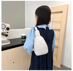 Close-up of white plush crossbody bag for kids showing soft lamb wool texture and zipper
