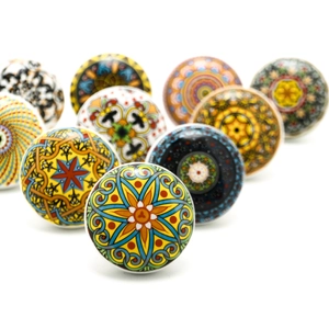 Group of decorative Bohemian ceramic knobs with vibrant ethnic patterns for cabinets.