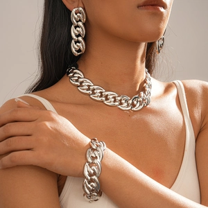 Close-up of chunky silver link chain jewelry set including necklace and bracelet