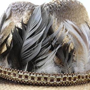 Close-up of natural feathers and woven decorative band on a raffia western cowboy hat