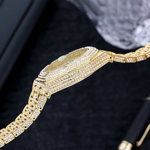 Detailed close-up of side bezel and gold band links fully set with sparkling diamonds
