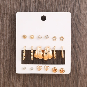 9 pairs of gold fashion earrings set featuring studs and hoops on a display card