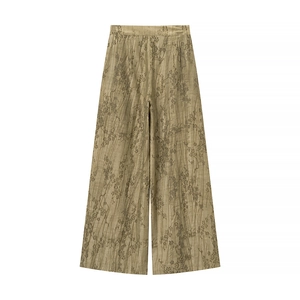 Detailed view of jacquard wide-leg trousers with traditional bird and leaf floral texture