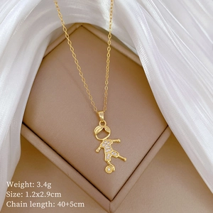 Detail of a gold soccer boy pendant with sparkling crystals in a beige jewelry box