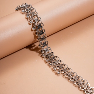 Detailed close-up of retro silver layered chain with embossed square links and small charms