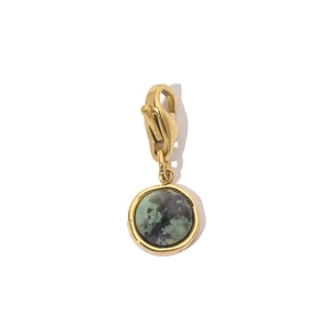 Detailed macro view of a natural green stone pendant with a gold lobster clasp
