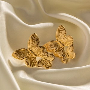 French vintage gold butterfly stud earrings on cream silk fabric, high-end metal jewelry