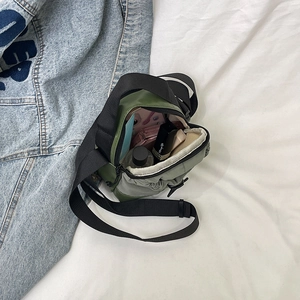 Lightweight army green mini crossbody bag showing interior capacity with drawstring closure