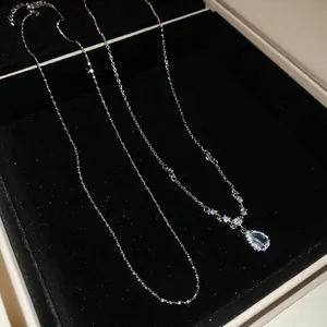 Elegant stainless steel chain necklace featuring a blue water drop gemstone pendant