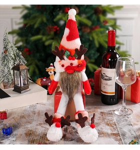 Detail of Christmas gnome with reindeer antlers and long legs in a festive home setting