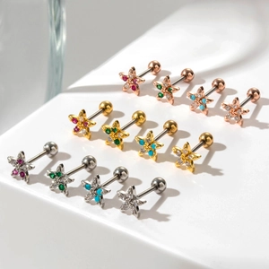 Detailed set of 12 star-shaped cartilage studs with colorful zircon stones in three metal tones