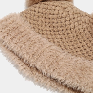 Detailed view of camel chunky knit beanie with thick plush lining and large faux fur pompom