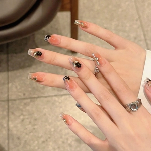 Elegant maple leaf style press-on nails with 3D black flowers and gold foil accents