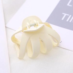 Close-up of matte beige octopus hair claw clip with strong metal spring for thick hair
