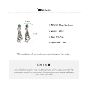 Detail view of boho tassel earrings with green teardrop stones and size measurements