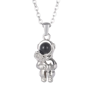 Silver astronaut necklace pendant holding a rose, minimalist stainless steel long chain style