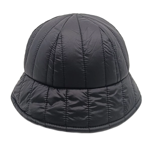 Detail of black quilted puffer bucket hat showing thermal insulation and waterproof fabric