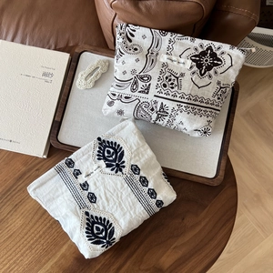 Linen paisley and ethnic embroidery storage bags with simple wish label on vintage wood