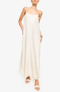 Detail of elegant cream satin maxi dress featuring delicate spaghetti straps and glossy finish