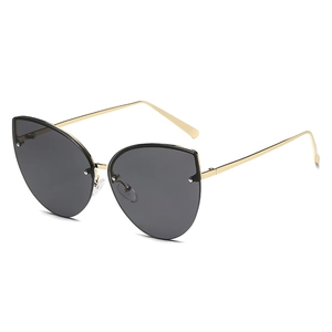 Modern cat-eye oversized sunglasses with gold metal frame and gradient dark grey lenses