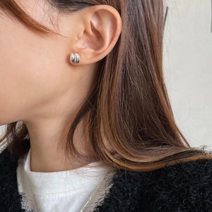 Minimalist 925 sterling silver geometric stud earrings shown on model's ear lobe