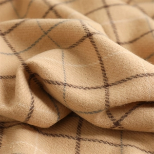 Close-up of soft beige and brown plaid fabric texture with detailed cashmere-like weave