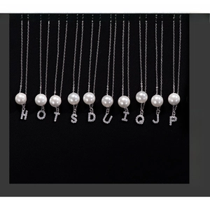 Detailed close-up of S925 silver alphabet pearl necklaces with sparkling zircon pendants