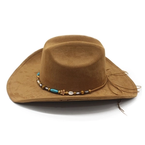Detail of bohemian decorative band with turquoise beads on brown suede cowboy hat
