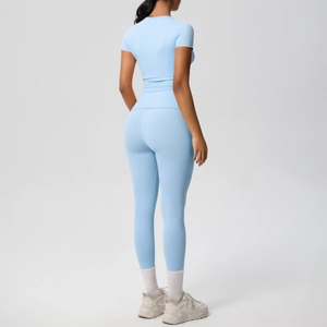 Back view of light blue athletic set featuring slim fit t-shirt and high waist yoga pants