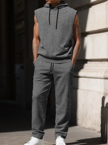 Close-up of grey sleeveless hooded sweatshirt and drawstring joggers in washed fabric