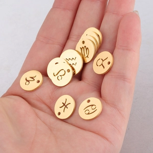Close-up of golden zodiac sign charms in 12mm mirror polished titanium steel pendants
