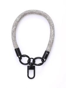 Close-up of grey woven phone lanyard with black metallic rings and rotating snap hook