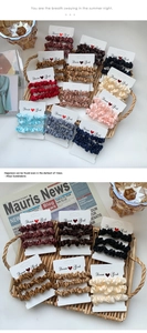 Three-pack satin hair scrunchies set in various elegant colors on a decorative card