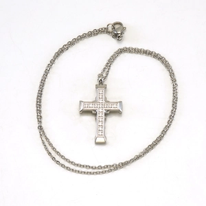Silver stainless steel cross pendant necklace with sparkling cubic zirconia on white background