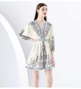 Detailed view of the deep V-neckline and intricate vintage print on the mini dress