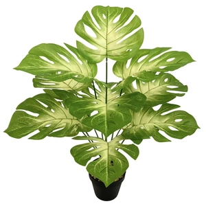 Lush artificial monstera plant in a simple black pot for modern Nordic home decoration