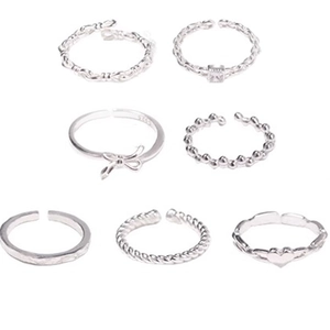 Detailed view of seven silver minimalist rings featuring S925 hallmark and diverse textures
