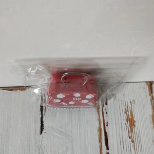 Close-up of a festive red Christmas tin candy box with Santa Claus motif and handle