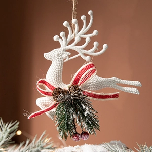 Sparkling white reindeer Christmas tree ornament with pine cones and red berries detail